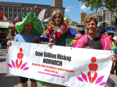 Putinca and Dandy Dugald holding a One Billion Rising banner at Norwich Markets.