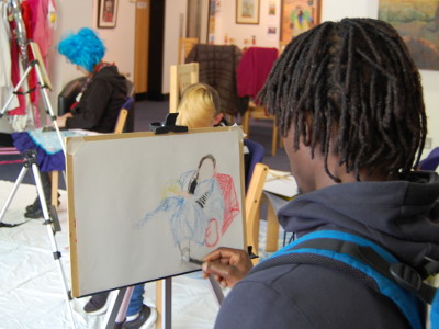 People painting and drawing at Dress, Pose and Paint Like a Dandy in Great Yarmouth Library.