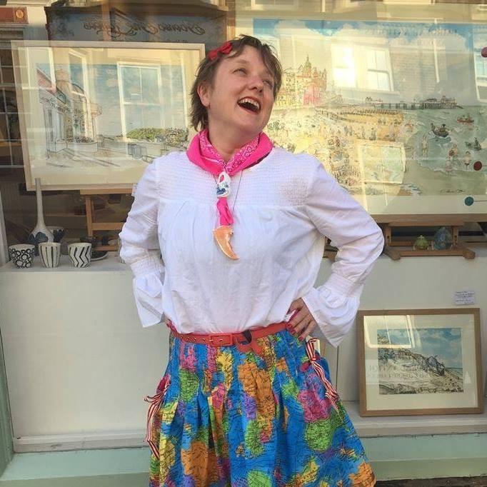 Eloise O'Hare posing outside Gallery Norfolk in Cromer. She is standing in front of the gallery, which has three of her paintings on display.