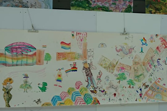 A close-up of the large scale community drawing of the Norwich Pride parade. TThroughout the exhibition day at the Forum people added their images to the parade drawing.