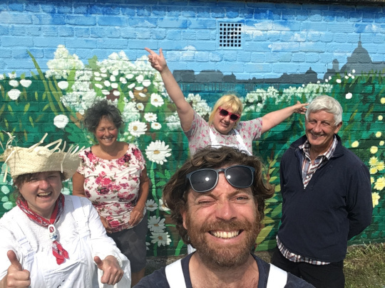 The Norwich Dandies with Beki, who helped paint the mural, and Trevor from Cromer Green Spaces.