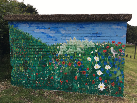 The left side of the mural, which features wild flowers and a seagull.