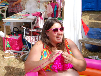 Dandy Chrissy in the paddling pool at the Safe Art Space, in front of a gazebo tent.