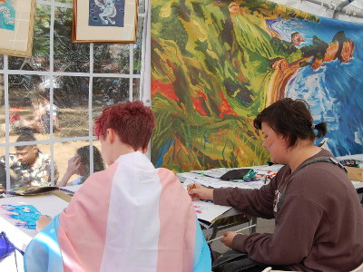 Two girls drawing at a table in the Safe Art Space.