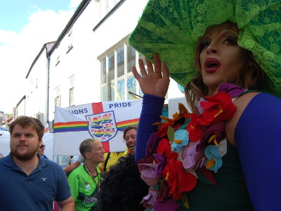Drag Queen Putinca, who helped us with the workshops, in the Pride Parade. She stands in front of the Lions Pride brigade.