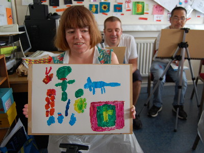 A Stepping Stones artist showing a abstract painting of various models and objects.